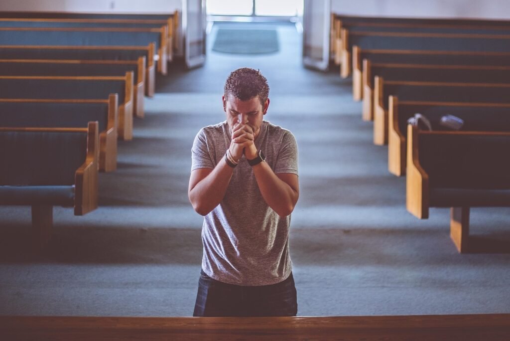 man praying in an empty church showing need for discipleship