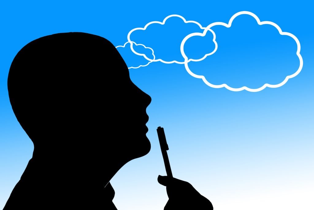Silhouette of a man in thoughtful pose with thought bubbles above, representing metacognition and thinking about thinking